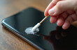 © Vadym - Hand cleans smartphone screen with cotton swab. Virus prevention concept. Digital device hygiene, antibacterial care, phone protection against germs, infection. Clean smart mobile.