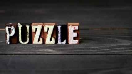 Wall Mural - puzzle concept. alphabet blocks on a wooden texture background. 4k video