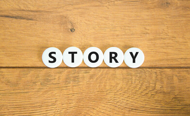 Fototapete - Story symbol. Concept word Story on beautiful white pills circles. Beautiful wooden table wooden background. Business lifestyle story concept. Copy space.