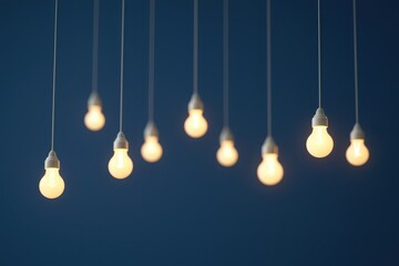 Poster - business bright idea concept. Hanging light bulbs against a dark blue background create a warm ambiance.