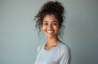 © miss irine - Portrait of smiling Indian woman. Female in 30s with healthy skin, wears sporty shirt against pastel grey background. AI generated photo. Focus on happy expression. Minimalist design.