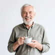 © Oleksandr - Happy senior man with a gray beard enjoying a cup of coffee and smiling warmly at the camera, creating a positive and inviting atmosphere .