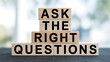 © Usman - Ask the right questions text on wooden blocks stacked on a dark surface