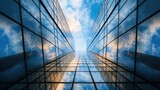 A striking view of tall glass skyscrapers reflecting clouds and blue sky, illustrating the awe-inspiring beauty of modern architecture in an urban setting.