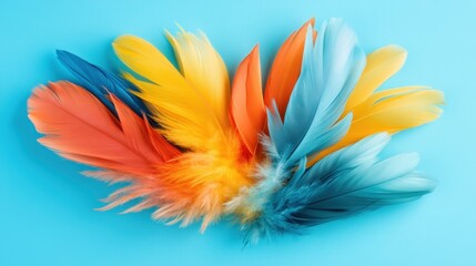 Poster - Vibrant feathers in orange, yellow, and blue form an eye-catching display against a bright blue background, symbolizing creativity and artistic expression in design.