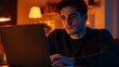 © Abdul - Photogenic European male in his 20s sitting at a desk with a laptop focused on work indoor lighting highlighting his sharp features isolated background