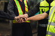 © NVB Stocker - team hands together. Professional team working at workplace. Unity and teamwork. Group portrait engineer factory manager worker and mechanic team together in factory workplace