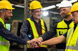 © NVB Stocker - team hands together. Professional team working at workplace. Unity and teamwork. Group portrait engineer factory manager worker and mechanic team together in factory workplace