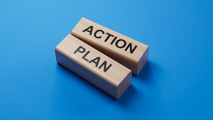 Poster - Action plan. wooden blocks spelling.Flat lay view from above on blue background with wooden blocks buttons.IT technology concept.3D rendering on blue background.
