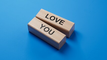 Poster - love you.wooden blocks spelling.Flat lay view from above on blue background with wooden blocks buttons.IT technology concept.3D rendering on blue background.