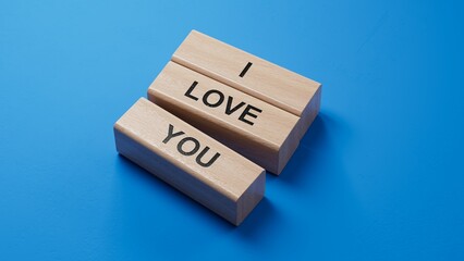 Poster - i love you.wooden blocks spelling.Flat lay view from above on blue background with wooden blocks buttons.IT technology concept.3D rendering on blue background.