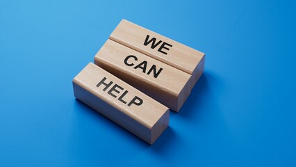 Poster - We can help symbol. wooden blocks with words We can help. Business and We can help concept. wooden blocks. Copy space.3D rendering on blue background.