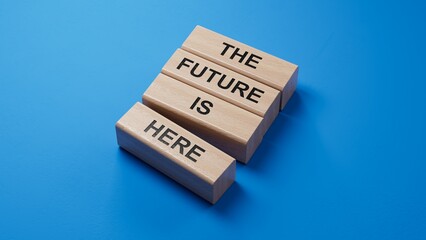 Poster - The future is here symbol. Concept words The future is here on wooden blocks.Business and The future is here concept. Copy space.3D rendering on blue background.