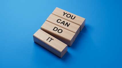 Poster - You can do it symbol. Concept words You can do it on wooden blocks.Business and You can do it concept.Copy space.3D rendering on blue background.