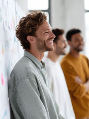 Poster - Diverse, happy team. Smiling young professionals collaborate, brainstorming by charts. Positive workplace culture. Growth, success, teamwork concept.