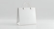© Nur - Blank White Paper Shopping Bag Mockup Isolated on White Background Perfect for Branding and Design Projects