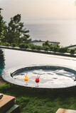 Colorful Cocktails by Bubble Jacuzzi in Poolside Hotel Room