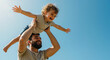 © Vasiliy - Happy bearded father lifting curly haired toddler son with arms spread against blue sky. Father's day celebration and family bonding activities