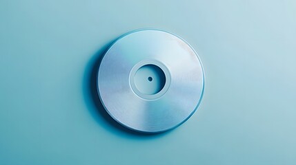 Poster - Polished, metallic disc on a light blue background.