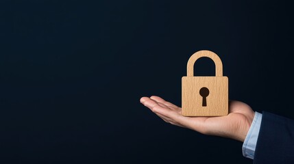 Poster - Wooden padlock held in a hand against a dark background representing security, privacy, and protection concepts