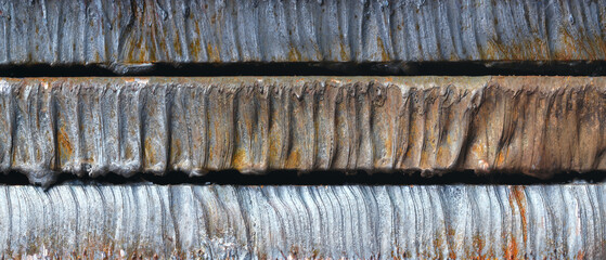 Aufkleber - Row of rusty metal sheets in cross-section with a grey-blue tint. sheets are arranged in a row, some overlapping each other scene is somewhat dark and melancholic as textured industrial background