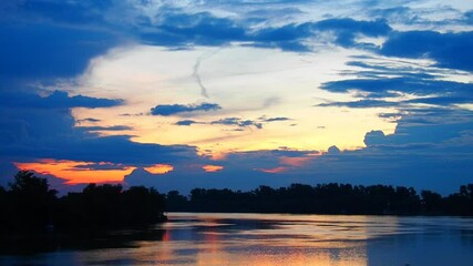 Poster - Experience the enchanting transformation of the Serbian sky as the sun sets over the river, painting the horizon with stunning hues. Witness natures artistry on display. River Sava at evening