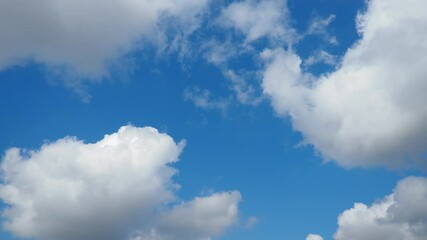 Poster - Observe the tranquil beauty of windy clouds as they gracefully move through a clear blue sky, captured in stunning slow motion to reveal their dynamic patterns and elegance