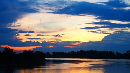 Poster - Experience the enchanting transformation of the Serbian sky as the sun sets over the river, painting the horizon with stunning hues. Witness natures artistry on display. River Sava at evening.