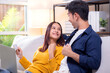 © NT_studio - Happy asian couple using laptop and credit card for online shopping together in living room at home, man and woman smiling and relax with enjoy a digital lifestyle, convenient payment.