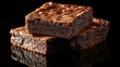 © Cholladda - Three Dark Chocolate Brownies Stacked on Black Reflective Surface