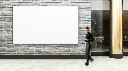 Poster - Blank advertising billboard on stone wall with blurred businesswoman walking by on street exterior of modern building facade for promotion display mockup.