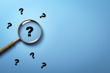 Fototapete - Magnifying glass highlighting black question mark on blue background surrounded by scattered question marks symbolizing uncertainty and search concept. 3D Rendering