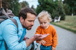 © Halfpoint - Father and son observing bug during nature walk