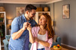 © Graphicroyalty - A couple is standing together, happily showing the key to their new home. The image captures excitement, achievement, and a fresh start as they celebrate homeownership in a joyful moment.