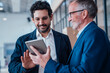 © Westend61 - Engineers discussing a project on a tablet indoors