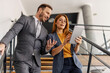 © Dusan Petkovic - Businesspeople in suit going down the stairs with tablet in hands.