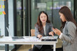 © aekachai - Two Asian businesswomen have a meeting in the office.