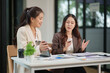 © aekachai - Two Asian businesswomen have a meeting in the office.