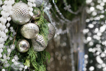 Wall Mural - elegant silver christmas decorations with bokeh and fir tree branch. silver festive background