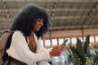 © bernardbodo - Tourist smiling and using mobile phone at the station