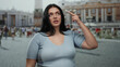 © Krakenimages.com - Young woman with dark hair stands confidently in outdoor setting at st. peter's square, showcasing cultural elegance and vibrant city backdrop in the vatican.
