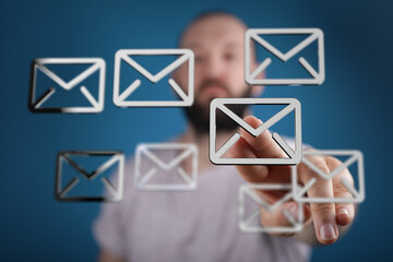 Poster - Stock photo of a man interacting with email icons on a digital interface.