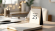 © Bonsales - Small desktop calendar marking December 25th, Christmas day, in a minimalist office scene with soft lighting