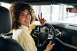 © standret - Feeling good, sitting and smiling. Happy woman is sitting in the car