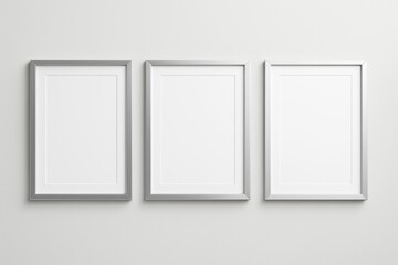 Poster - Three vertical silver photo frames on light wall background with blank space for mockup design, poster template or branding concept.
