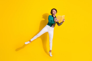 Poster - Full length photo of charming glad cheerful woman wear stylish clothes hold book isolated on yellow color background
