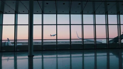 Aufkleber - Spacious airport terminal featuring expansive glass windows revealing passenger jet taking off against soft hued dawn sky, highlighting modern architectural elegance and tranquil travel environment