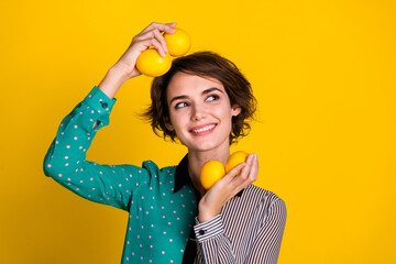 Poster - Photo of dreamy lovely nice woman wear trendy clothes hold fresh lemon look empty space isolated on yellow color background