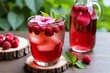 © Alex & M Studio - refreshing glass of raspberry hibiscus tea, garnished with a pink flower and served next to a pitcher, sits on wooden coasters outdoors, creating a beautiful and natural summer drink scene