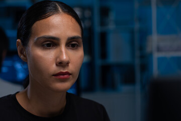 focused of hispanic young professional female software developer coding program on desktop computer 